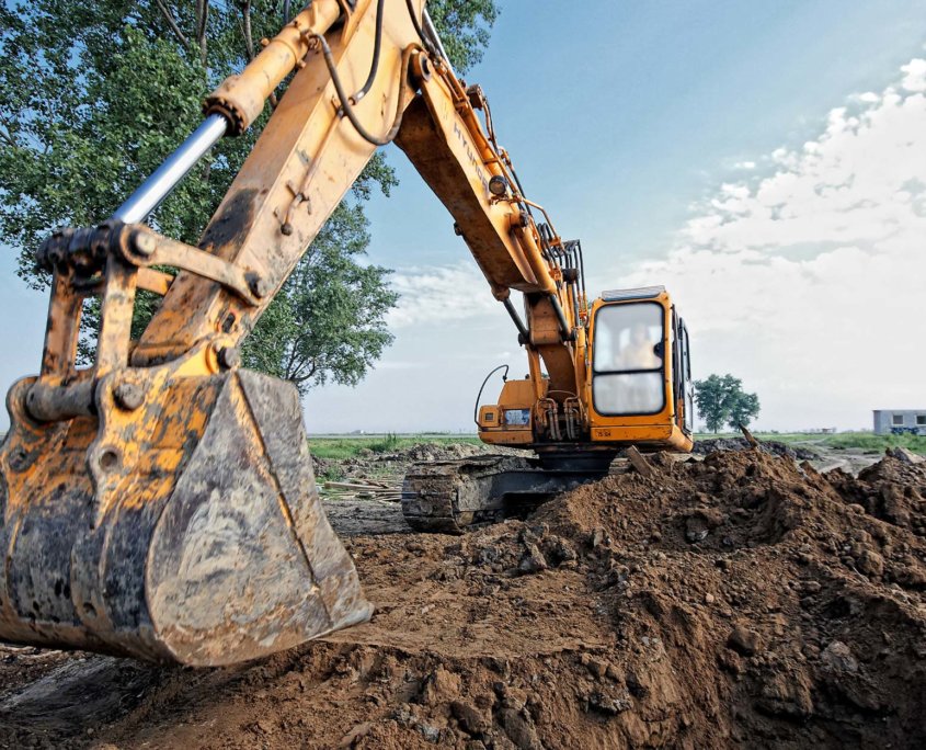 Heavy-earth-moving-equipment-on-site-with-tree
