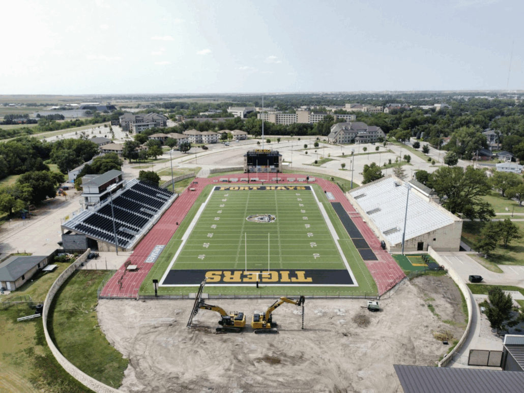 Aerial view of Fort Hays State University’s Lewis Field Stadium with CNC Foundations’ aggregate pier ground improvement work underway in the end zone. Excavators are visible preparing deep fill soils for future stadium expansion, showcasing site-wide soil stabilization strategy.