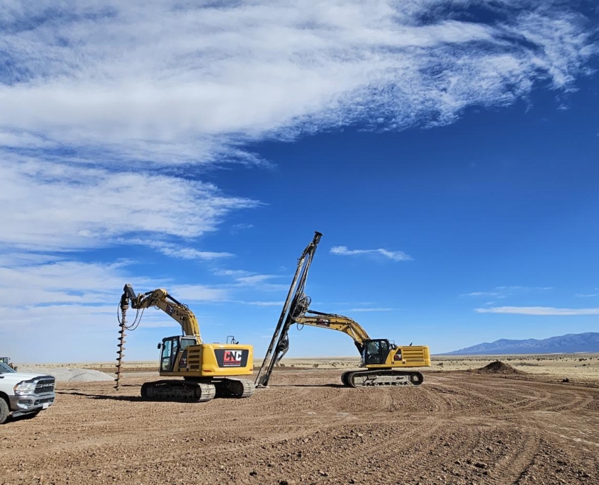 Two CNC Foundations rigs and a service truck onsite at SunZia Wind Farm, performing deep foundation work including aggregate pier drilling to stabilize soil beneath wind turbine foundations.