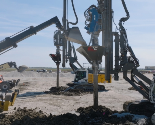CNC Foundations ground improvement contractors installing stone columns with specialized equipment at a commercial construction site.