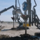 CNC Foundations ground improvement contractors installing stone columns with specialized equipment at a commercial construction site.