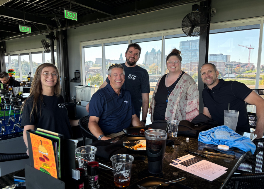 CNC team gathered at a rooftop bar