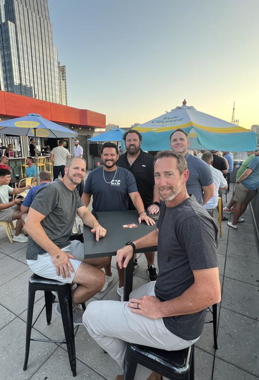 CNC teammates at an outdoor patio table
