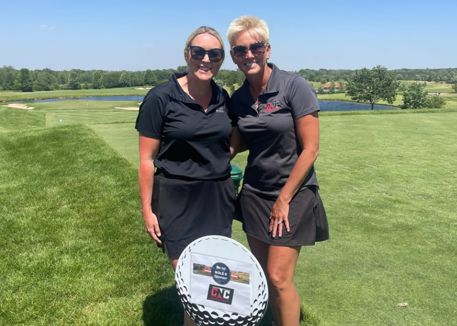 Two CNC teammates at a company golf outing
